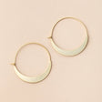 a pair of gold hoop earrings that take the shape of a crescent moon