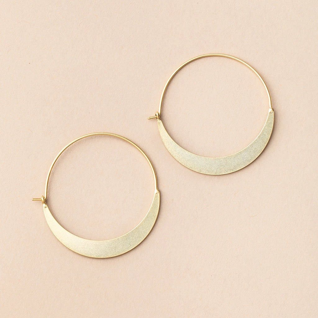 a pair of gold hoop earrings that take the shape of a crescent moon