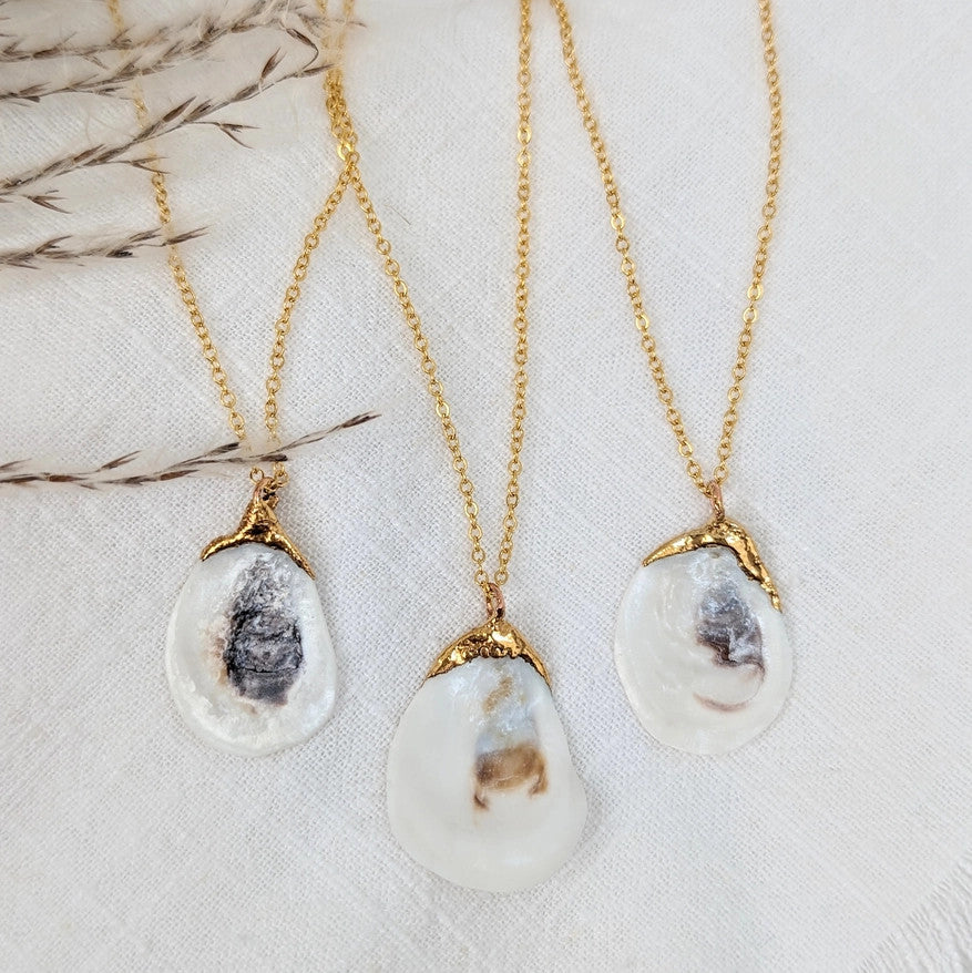 a grouping of 3 Oyster Shell necklaces to show the variation in shell size as well as unique qualities that occur with every shell
