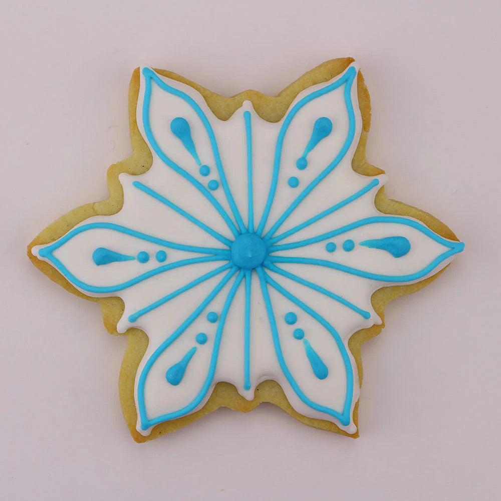 Icy Snowflake shaped cookie with white icing with blue piped snowflake detailed decor