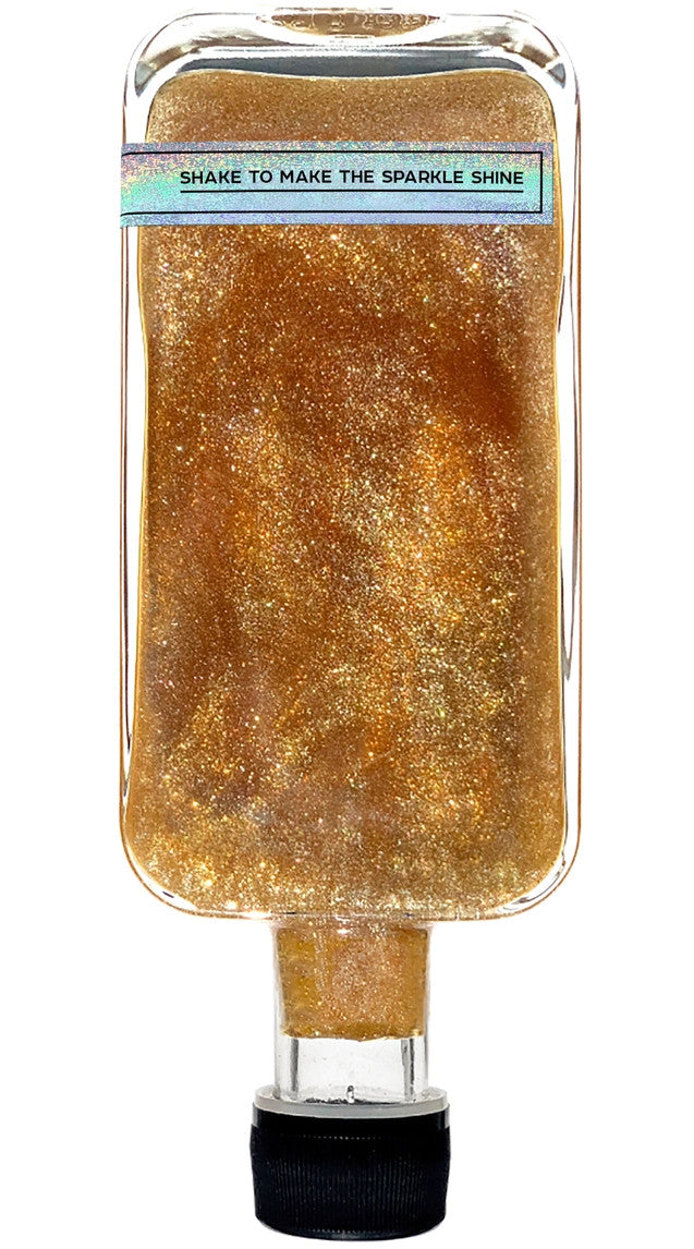 upside down, back side of the bottle showing the label that reads "shake to make the sparkle shine"