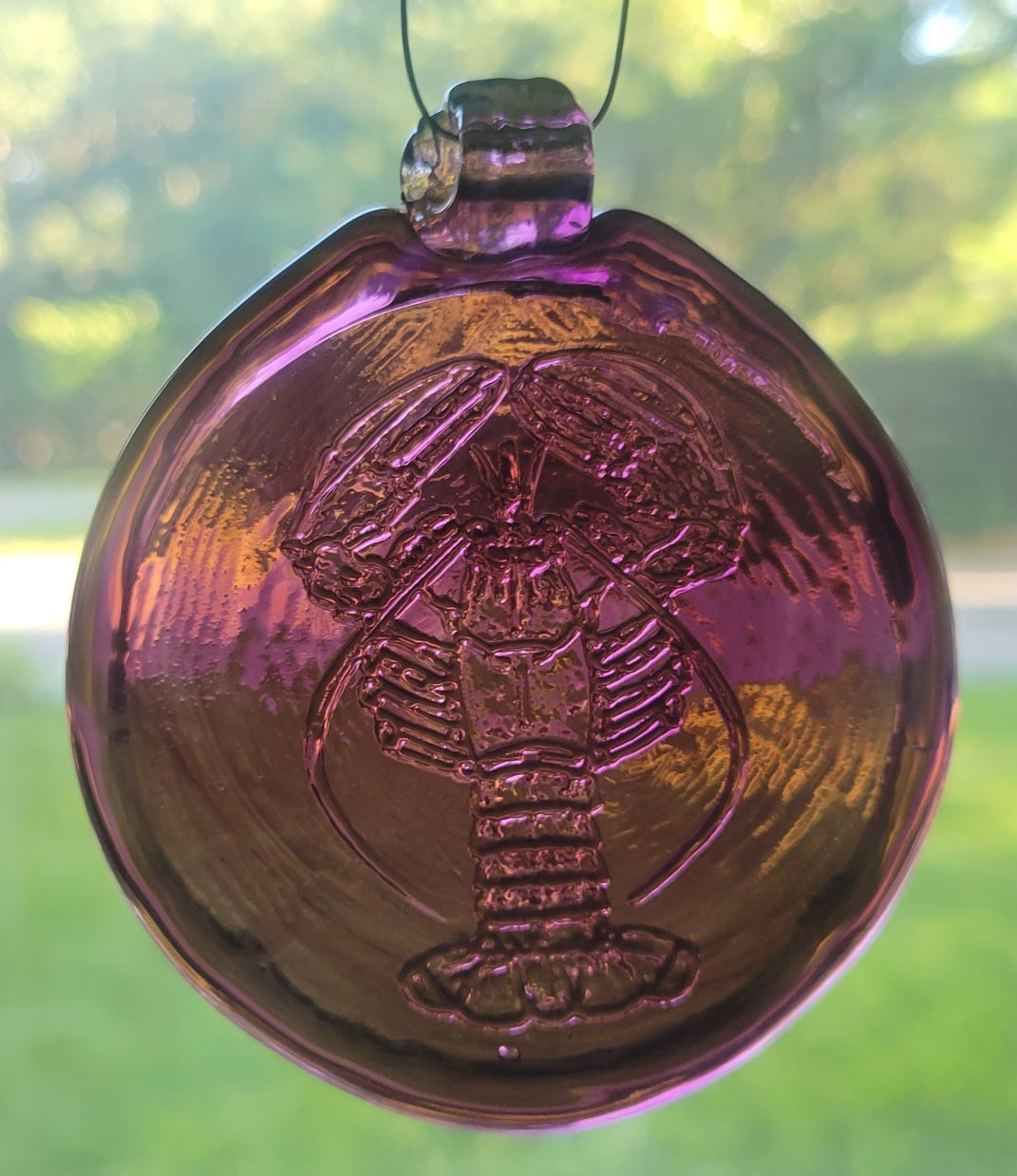 Purple glass suncatcher with realistic lobster design.