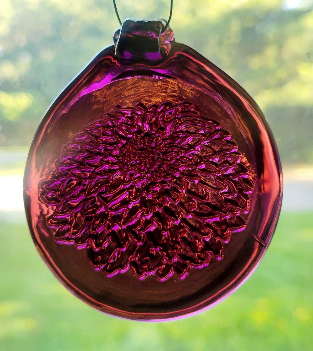 Dark purple glass suncatcher with a chrysanthemum flower design.