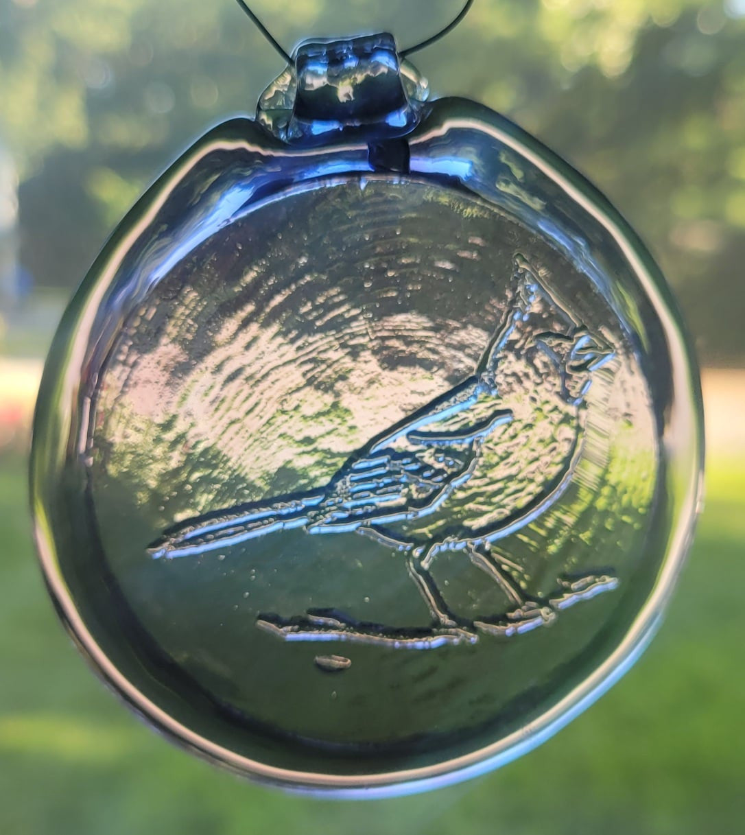Light purple glass suncatcher with a folk art cardinal design.