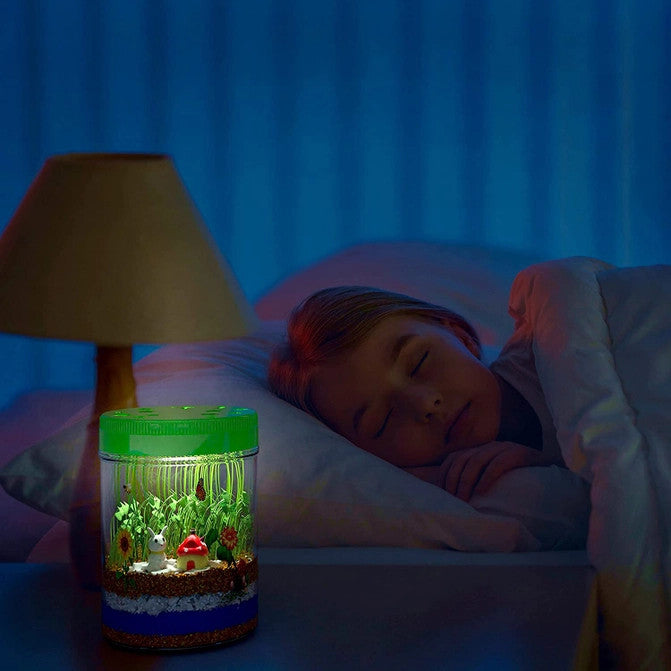 kids light up terrarium lit up at night on a bedside table showing a subtle glow