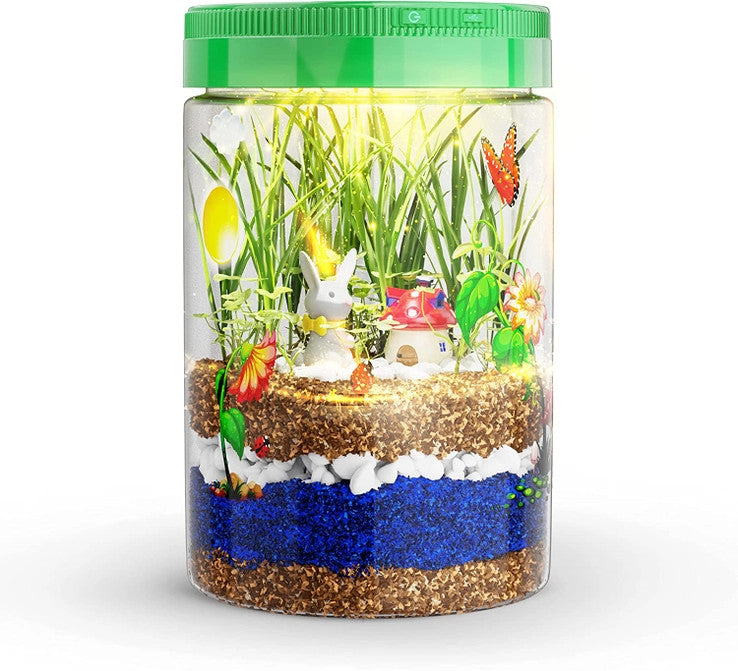 kids light up terrarium showing growing plants, decorative figures and stickers, and layers of soil
