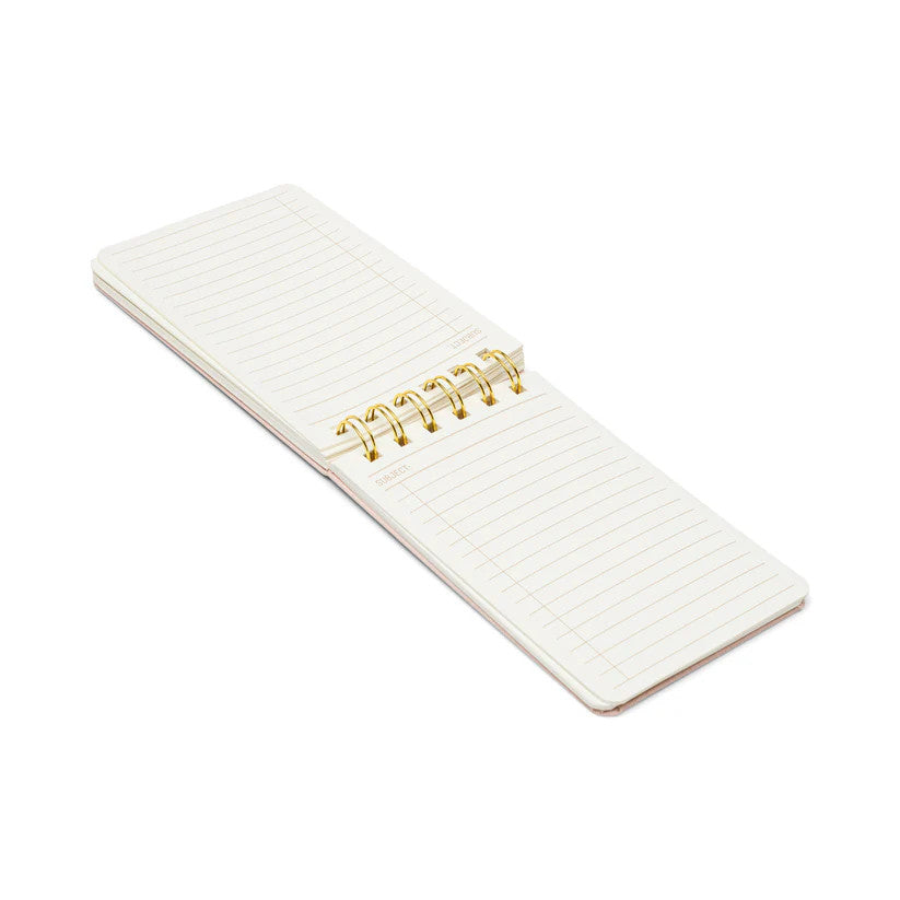 an open, laid flat twin wire notebook shown at an angle revealing the lined, interior pages of the notebook