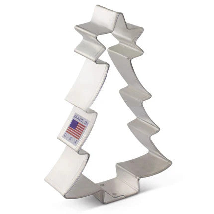 Tin cookie cutter in the shape of a Christmas tree with a star topper
