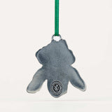 back of the iris-shaped ornament with a green string on a white background