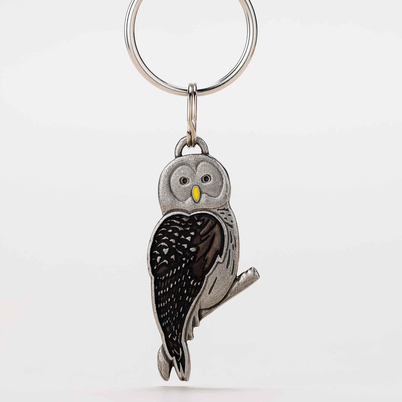 barred owl keyring front design - pewter with brown feathers and a yellow beak