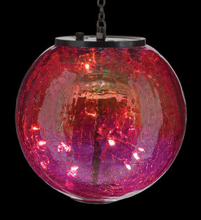 close up view of a round, red and pink glass globe lantern with crackle texture on glass illuminated -  On/off switch and hanging chain visible at top of globe