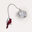 Tea ball with red cardinal bird design on a white background