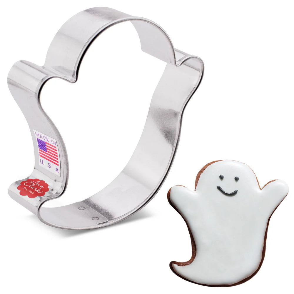 a ghost shaped cookie cutter alongside a decorated ghost shaped cookie
