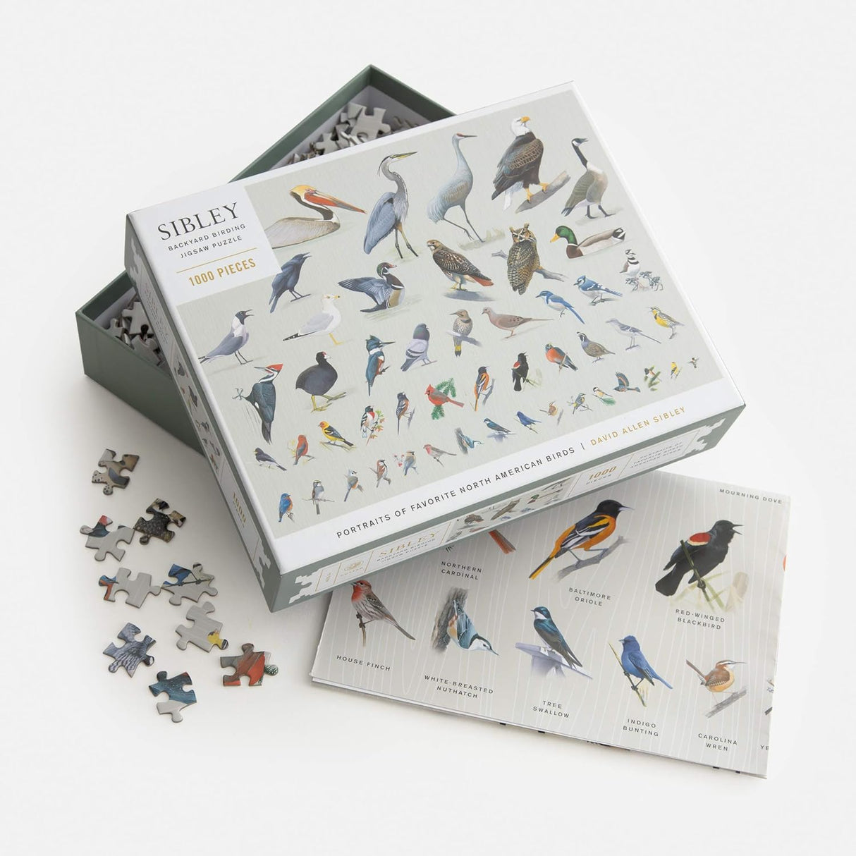 Bird-themed puzzle set with pieces and packaging on a white background