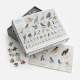 Bird-themed puzzle set with pieces and packaging on a white background
