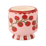 Ceramic candle vessel with red tomato design on a white background