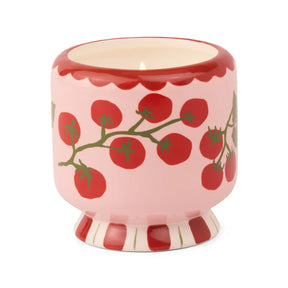 Ceramic candle vessel with red tomato design on a white background