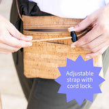 Person adjusting an adjustable strap with a cord lock on a bag.