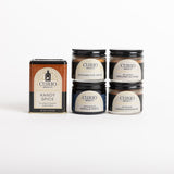 Curio Spice Co. spice collection set featuring a tin of Kandy Spice and four glass jars of spices (Sichuan Five Spice, Vanilla Paste, Ground Nutmeg, Cassis Cinnamon) on a white background.