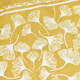 close up of illustration detail of White ginkgo leaf pattern on a mustard yellow bandana