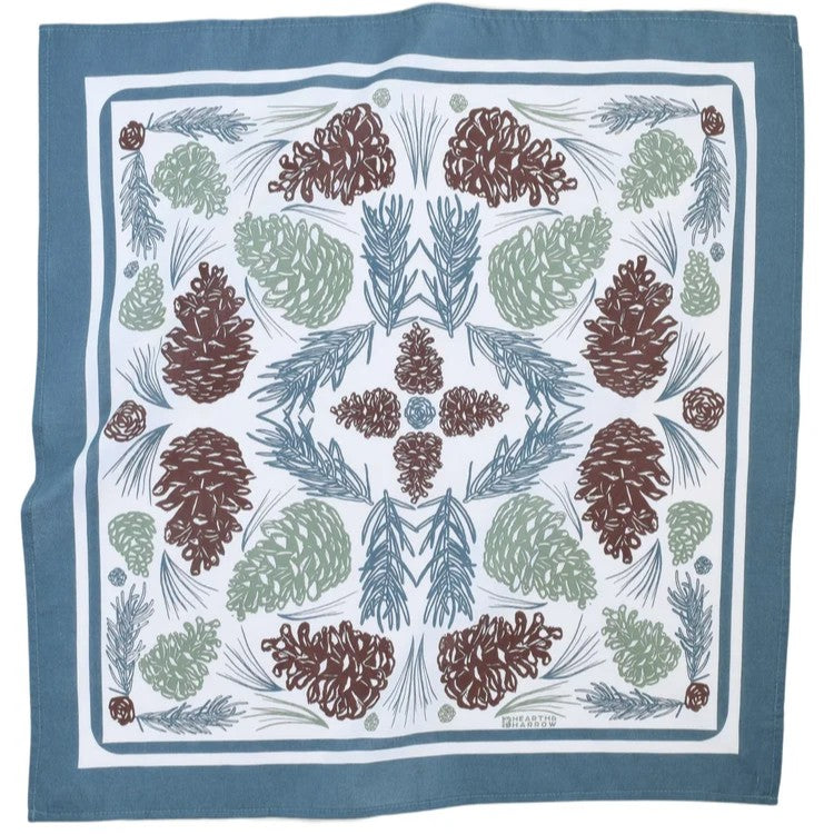 Fabric bandana with pine cone and leaf pattern on a blue background