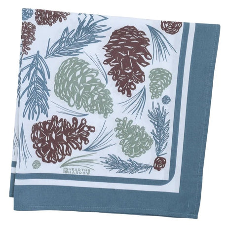 folded bandana with pine cone and leaf pattern on a blue background