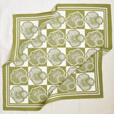 Green and white checkered bandana with tree ring pattern on a white background