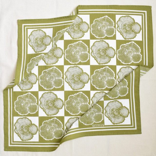 Green and white checkered bandana with tree ring pattern on a white background