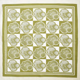 Square bandana with a pattern of tree rings on a green and white checkered background