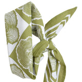 Green and white patterned scarf tied in a knot on a white background