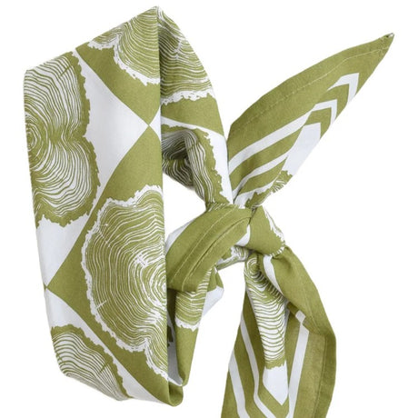 Green and white patterned scarf tied in a knot on a white background