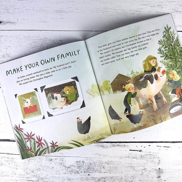 Open book with illustrations of children and animals on a wooden surface