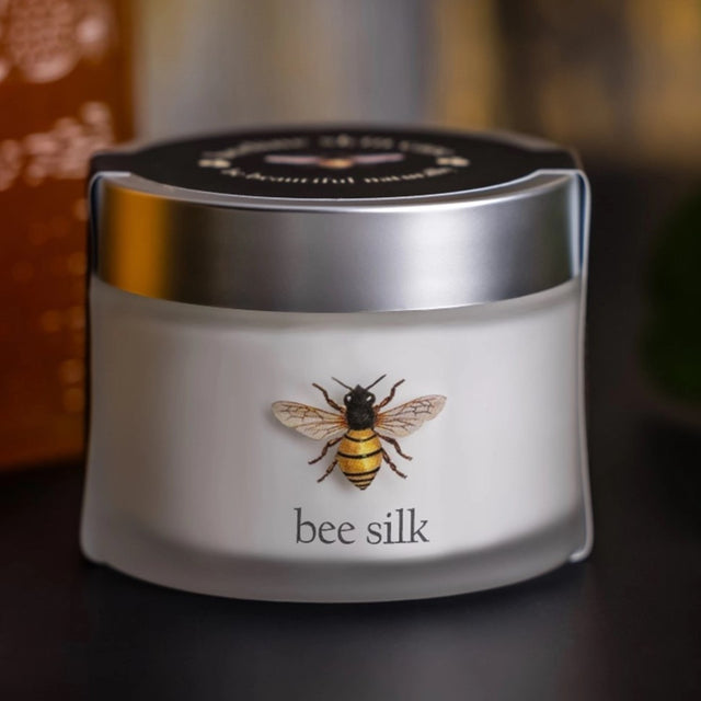 Bee Silk Moisturizer - a frosted clear glass jar with silver top and bee illustration label above the text "bee silk"