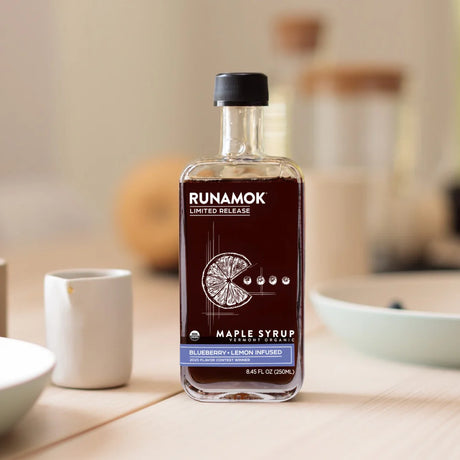 Bottle of Runamok Maple Syrup on a kitchen counter with blurred background