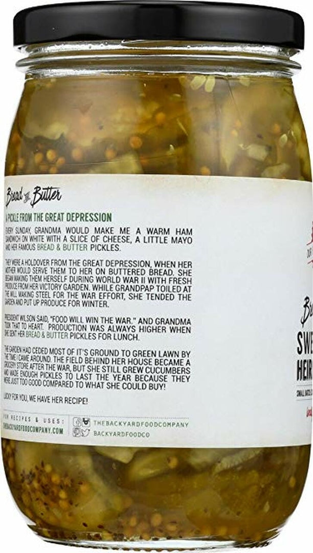 A jar of Pickled Herbs and Herbs and Herbs with a black lid and a white label showing the back text, photographed on a white background.