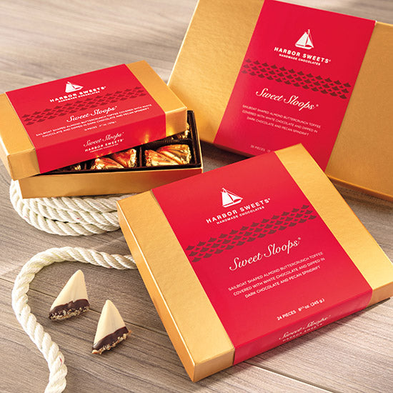Harbor Sweets Sweet Sloops chocolate boxes on a wooden surface with a rope.