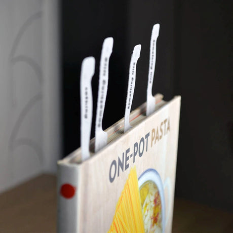 pasta book standing up with cookmarks marking several pages