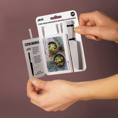 two hands holding the cookmarks package