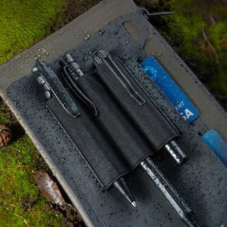 a close up of the pen slots filled with pens, and cards slipped inside the card holders