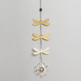 Decorative hanging chain with 3 brass dragonfly cutouts with a blue apatite stone above them and a crystal daisy hanging below
