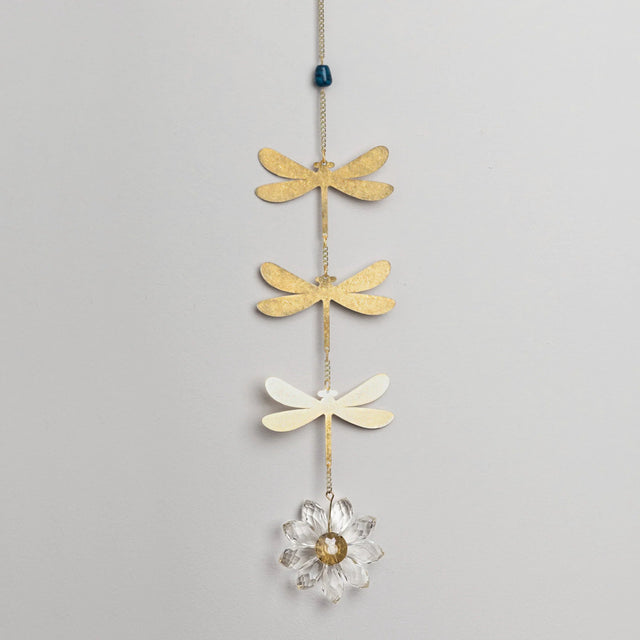 Decorative hanging chain with 3 brass dragonfly cutouts with a blue apatite stone above them and a crystal daisy hanging below