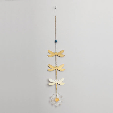 Decorative hanging with gold dragonflies and a white flower on a gray background