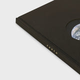 Black book with 'EARTH' embossed on it, featuring a circular cutout revealing Earth.
