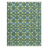 Patterned blanket with green and blue design on a white background