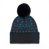 A black knit pom-pom beanie with a ribbed cuff, featuring a patterned band of teal, blue, and gray fair isle motifs.