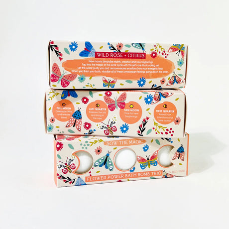Three stacked boxes of Wild Rose Citrus bath bombs with colorful designs on a white background