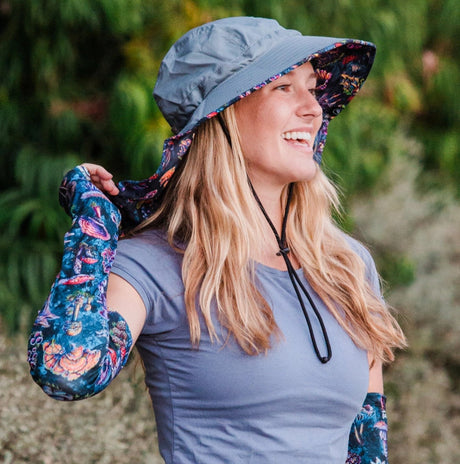 a model wearing the Sun Hat and matching protection sleeves outdoors