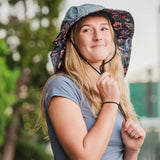 a model wearing the Sun Hat and matching protection sleeves outdoors