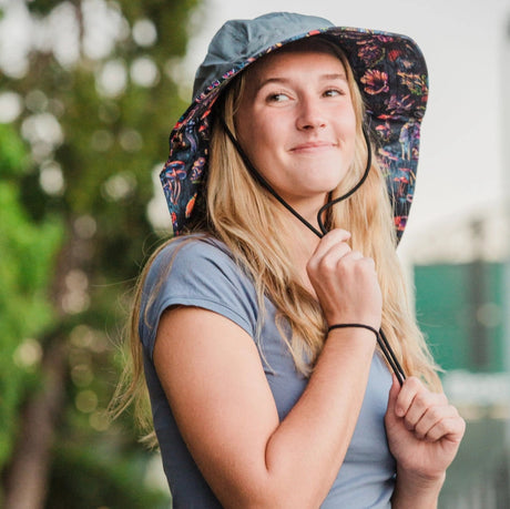 a model wearing the Sun Hat and matching protection sleeves outdoors