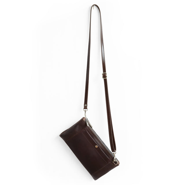 A dark brown leather crossbody bag with a long adjustable shoulder strap and silver-tone hardware, shown against a plain white background.